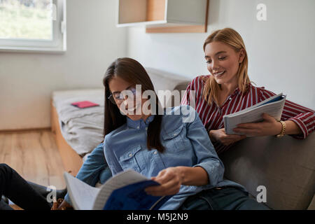 Happy students in dormitory learning together Stock Photo
