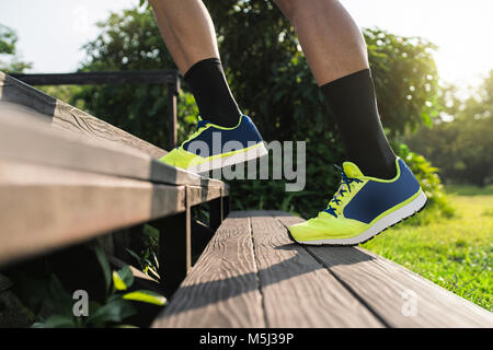 Runner training running up stairs, close up Stock Photo