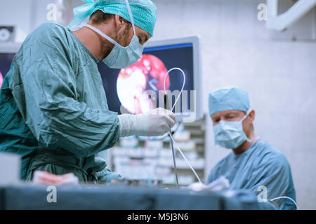 Surgical nurse at work during an operation Stock Photo