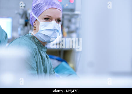 Surgeon in scrubs during an operation Stock Photo