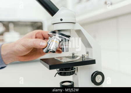 Close-up of laboratory technician using microscope in lab Stock Photo