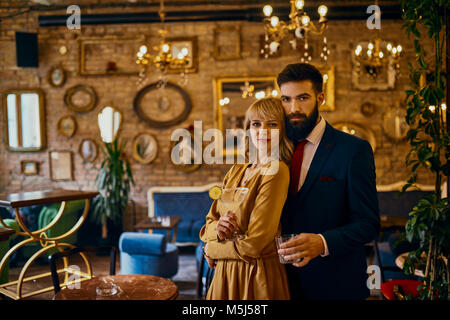 Portrait of elegant couple with drinks in a bar Stock Photo