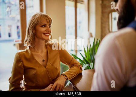 Elegant smiling woman with man in a bar Stock Photo