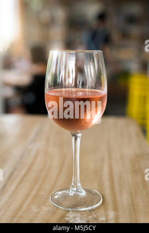 Glass of rose wine on wooden tale Stock Photo