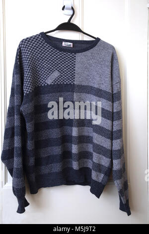 Knitted Wool Aldani Jumper Made in Italy Hanging On Door Stock Photo