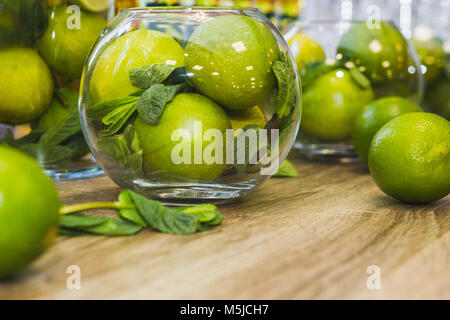 Green fruits - Limes with mint on wooden table Stock Photo