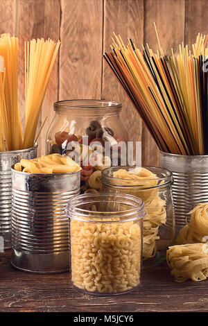 Different types of Italian pasta  for healthy cooking on wooden table. Stock Photo