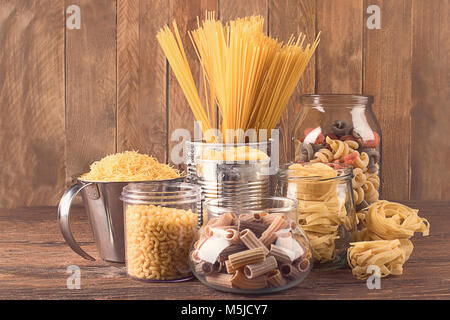 Different types of Italian pasta  for healthy cooking on wooden table. Stock Photo