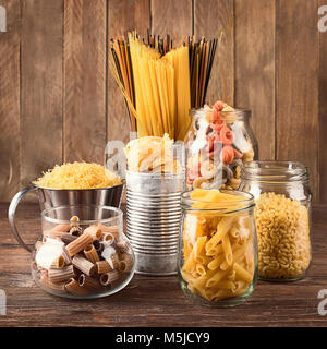 Different types of Italian pasta  for healthy cooking on wooden table. Stock Photo