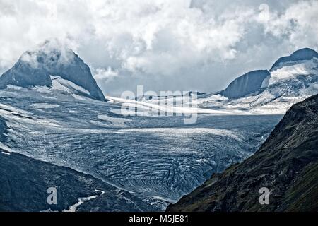 Gries Glacier is one of many above the Nufenenpass, with a summit ice cap supplying the valley glacier below. Stock Photo