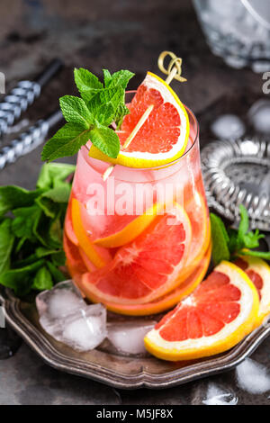 Grapefruit and fresh mint cocktail with juice, cold summer citrus refreshing drink or beverage with ice Stock Photo