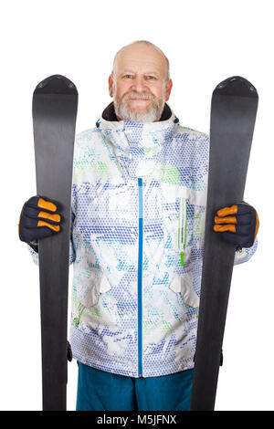 Handsome mature man in ski suit, holding skis on isolated background Stock Photo