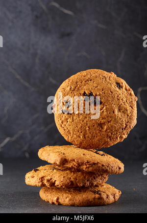 Close-up picture of chocolate cookies on dark background, shallow depth of field, lowkey. Extremely detailed. Delicious and tasty snack. Stock Photo