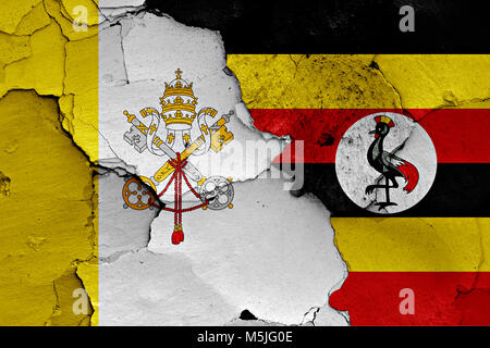 flag of Vatican and Uganda painted on cracked wall Stock Photo