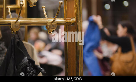 Wardrobe - cloakroom in hall of theatre -the audience pass the clothes in the closet Stock Photo