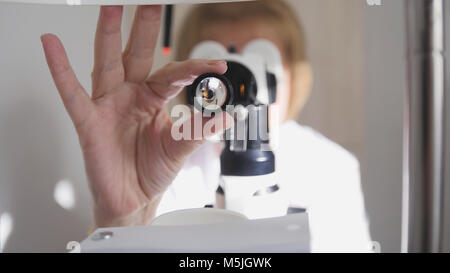 Healthcare - optometrist - doctor ophthalmology examining patient's eyes - medical concept Stock Photo
