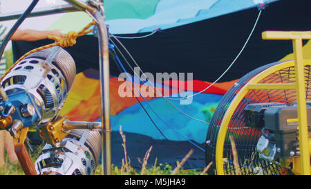 Gasoline burner burns hot air colorful balloon, close up Stock Photo