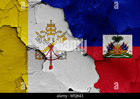 flag of Vatican and Haiti painted on cracked wall Stock Photo