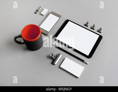 Blank stationery and gadgets on grey paper background. Brand ID template. Stock Photo