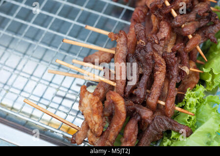 Close up Fried Pork stick on grid  market, Thai cuisine traditional signature street food, quick delicious and easy eating, write copy space Stock Photo