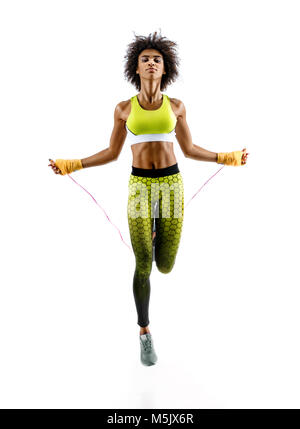 Athletic black girl exercising with skipping rope at park Stock Photo -  Alamy