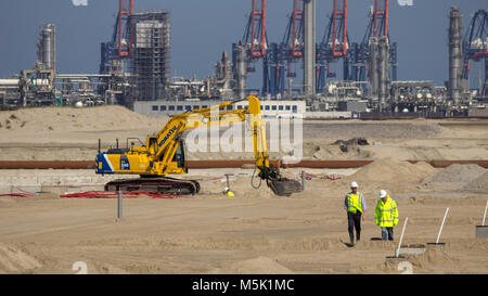 ROTTERDAM, NETHERLANDS - SEP 8, 2012: Construction workers and a Komatsu PC240-6 hydraulic excavator on the construction site of Maasvlakte 2 in the P Stock Photo