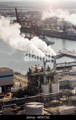 Air pollution from chimney exhaust at a petrochemical plant in a large industrial port. Stock Photo