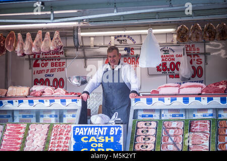 Butcher with his shop or stall, UK Stock Photo