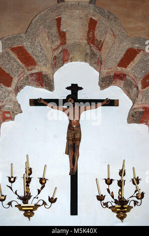 Statue of the crucifixion and moorish arch in the Villaviciosa chapel of the Mezquita - Cordoba, Andalusia, Spain Stock Photo