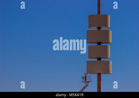 Worker On Cherry Picker Repairing Giant Sign Stock Photo