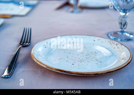 Table setting with fork, plate and glass Stock Photo