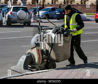 Voronezh, Russia - April 27, 2017: Cleaning the street with a manual sweeper Stock Photo