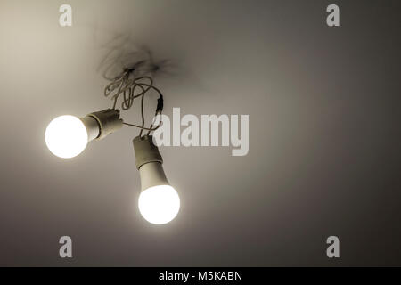 Two white electric bulbs on ceiling Stock Photo