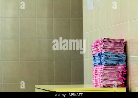 Stack of pink bath towels close-up with blurred background Stock Photo