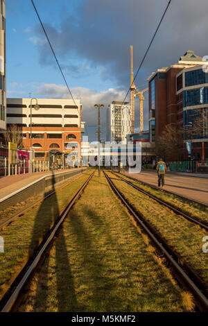 Late afternoon sun on the tracks at the Harbour City Metrolink tram stop, Salford Quays, Manchester, UK Stock Photo