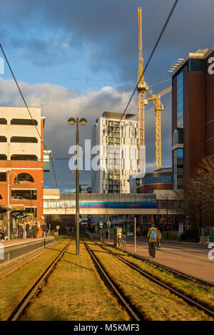 Late afternoon sun on the tracks at the Harbour City Metrolink tram stop, Salford Quays, Manchester, UK Stock Photo