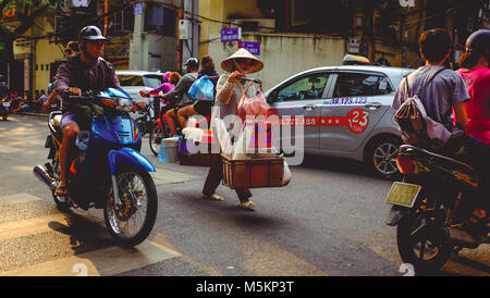 Busy streets are full of traffic and market traders in Hanoi, Vietnam Stock Photo