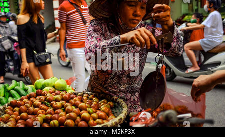 Busy streets are full of traffic and market traders in Hanoi, Vietnam Stock Photo