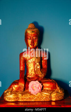 Statue of a red golden buddha Stock Photo