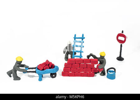 Abstract photo of buildings works. Figures made from Play Clay. Isolated on white background. Stock Photo