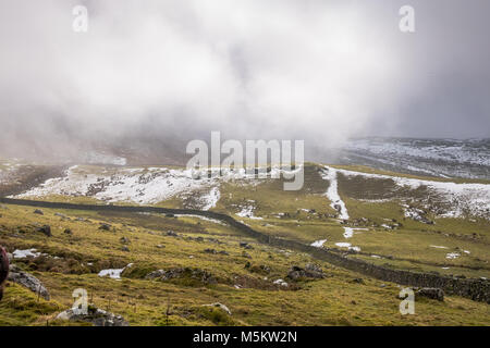 Patches of snow on fields seen through low clouds near the Settle Loop in theYorkshire Dales Stock Photo