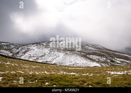 Patches of snow on fields seen through low clouds near the Settle Loop in theYorkshire Dales Stock Photo