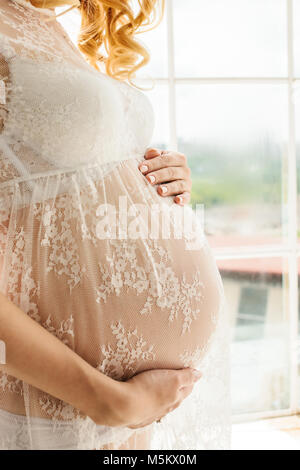 Beautiful adult pregnant woman. Waiting for the baby. Pregnancy. Care, tenderness, motherhood, childbirth. Stock Photo