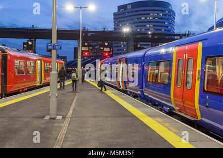 Passengers waiting to commute on two South West Trains on the platform at Waterloo station Stock Photo