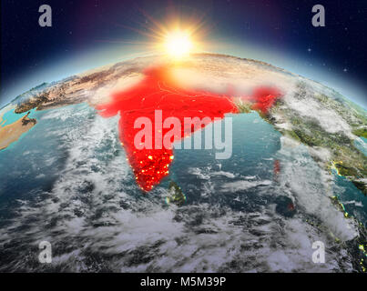 Satellite view of India highlighted in red on planet Earth with clouds during sunrise. 3D illustration. Elements of this image furnished by NASA. Stock Photo