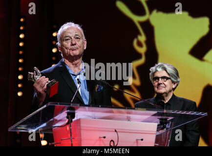 Berlin, Germany. 24th Feb, 2018. Voice actor of animation film 'Isle of Dogs' Bill Murray (L) receives the Silver Bear for Best Director award on behalf of director Wes Anderson during the awards ceremony of the 68th Berlin International Film Festival, in Berlin, Germany, on Feb. 24, 2018. Credit: Shan Yuqi/Xinhua/Alamy Live News Stock Photo