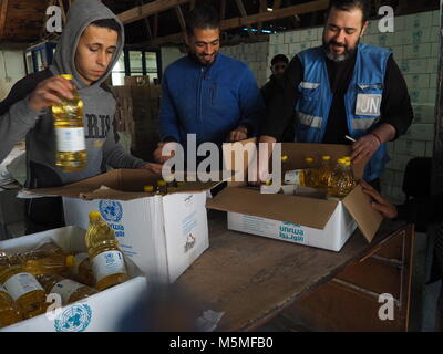 Gaza, Palestinian Territories. 13th Feb, 2018. Men carry food sacks in an aliment distribution centre of UNRWA in Gaza, Palestinian Territories, 13 February 2018. UNRWA distributes basic aliments to approximately one million people in Gaza. Credit: Stefanie Järkel/dpa/Alamy Live News Stock Photo