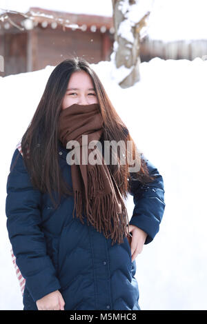girl teenage on the snow day enjoying herself on a cold winter day in Japan Stock Photo