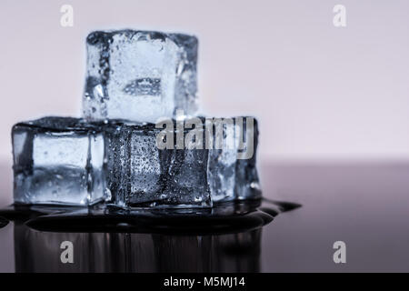 Many ice cubes on black reflection background Stock Photo