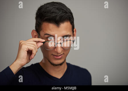 Man putting glasses down portrait. Attractive man in glasses Stock Photo